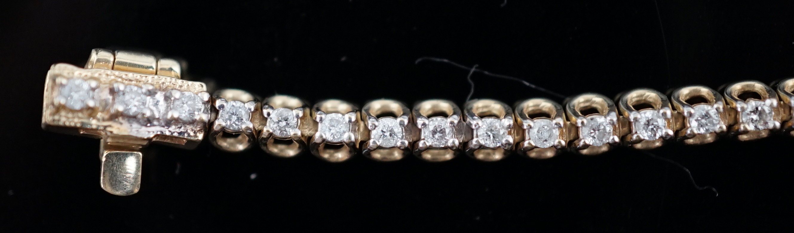 A modern 9ct gold and diamond chip set line bracelet